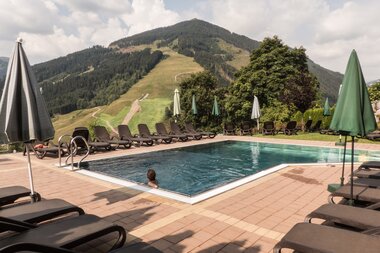 Außenpool mit Liegen bei schönem Bergpanorama | © Hotel Eggerhof